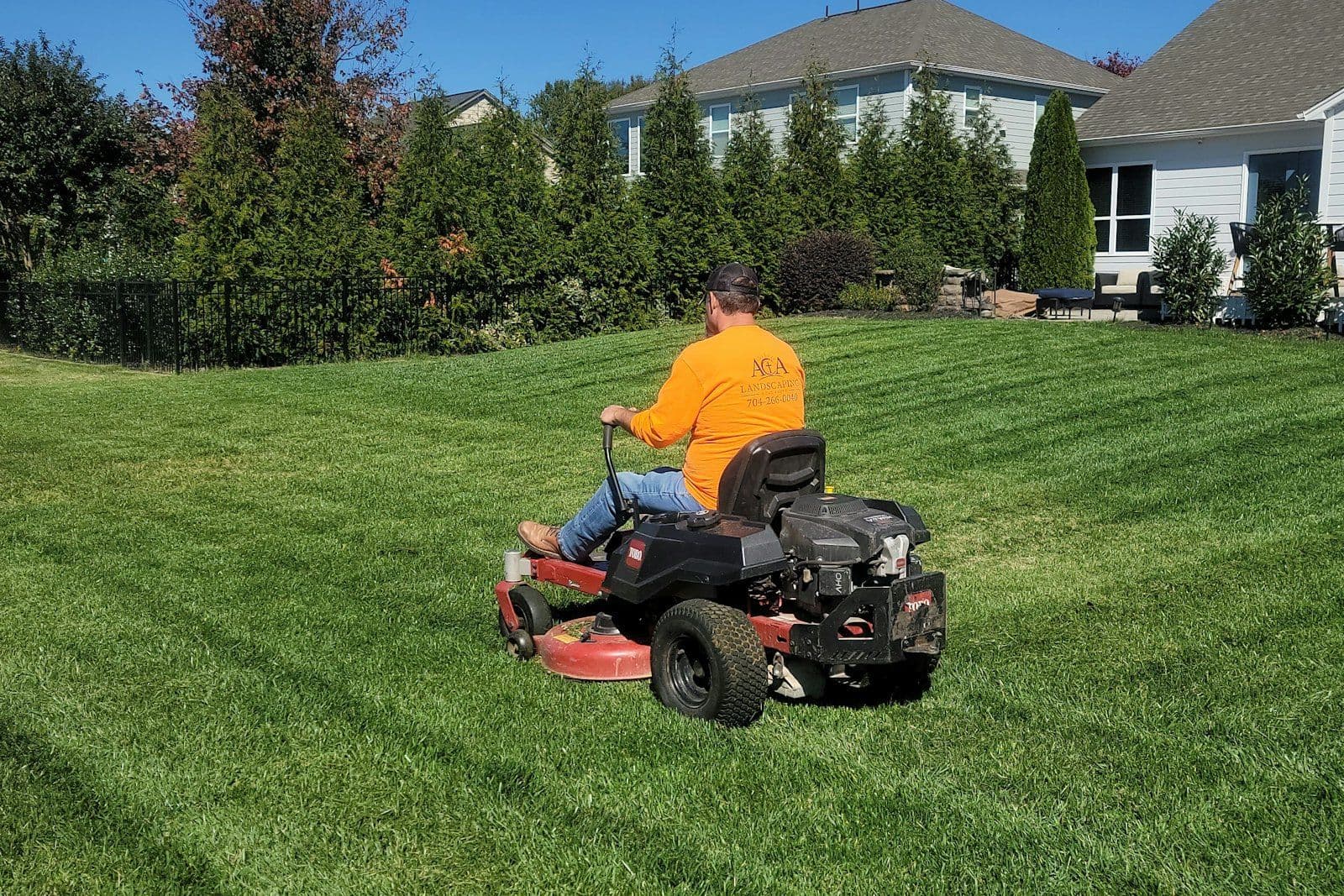 Commercial lawn care crew mowing a business property lawn