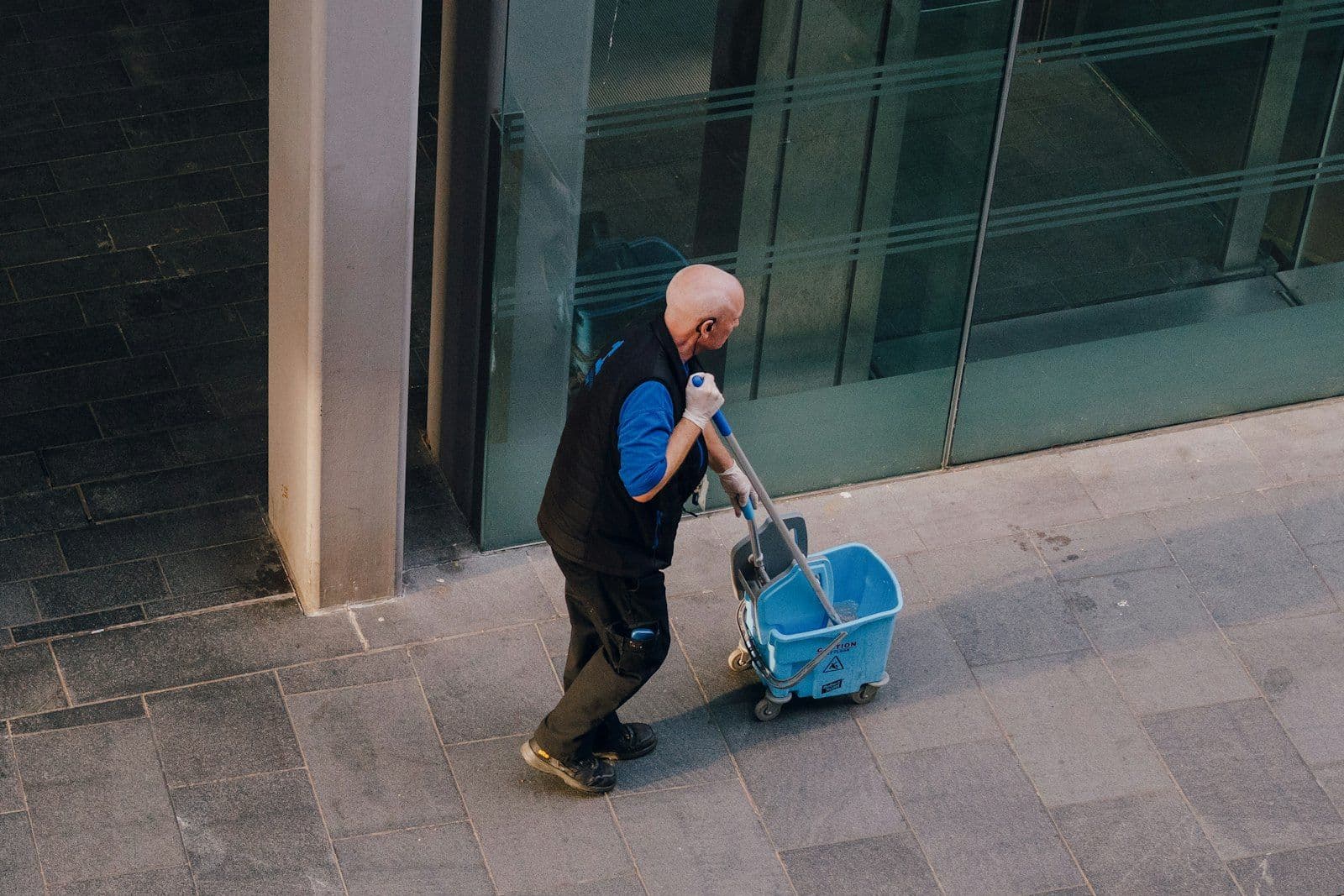 Capital Commercial Services crew member with a janitorial cart outside a commercial building