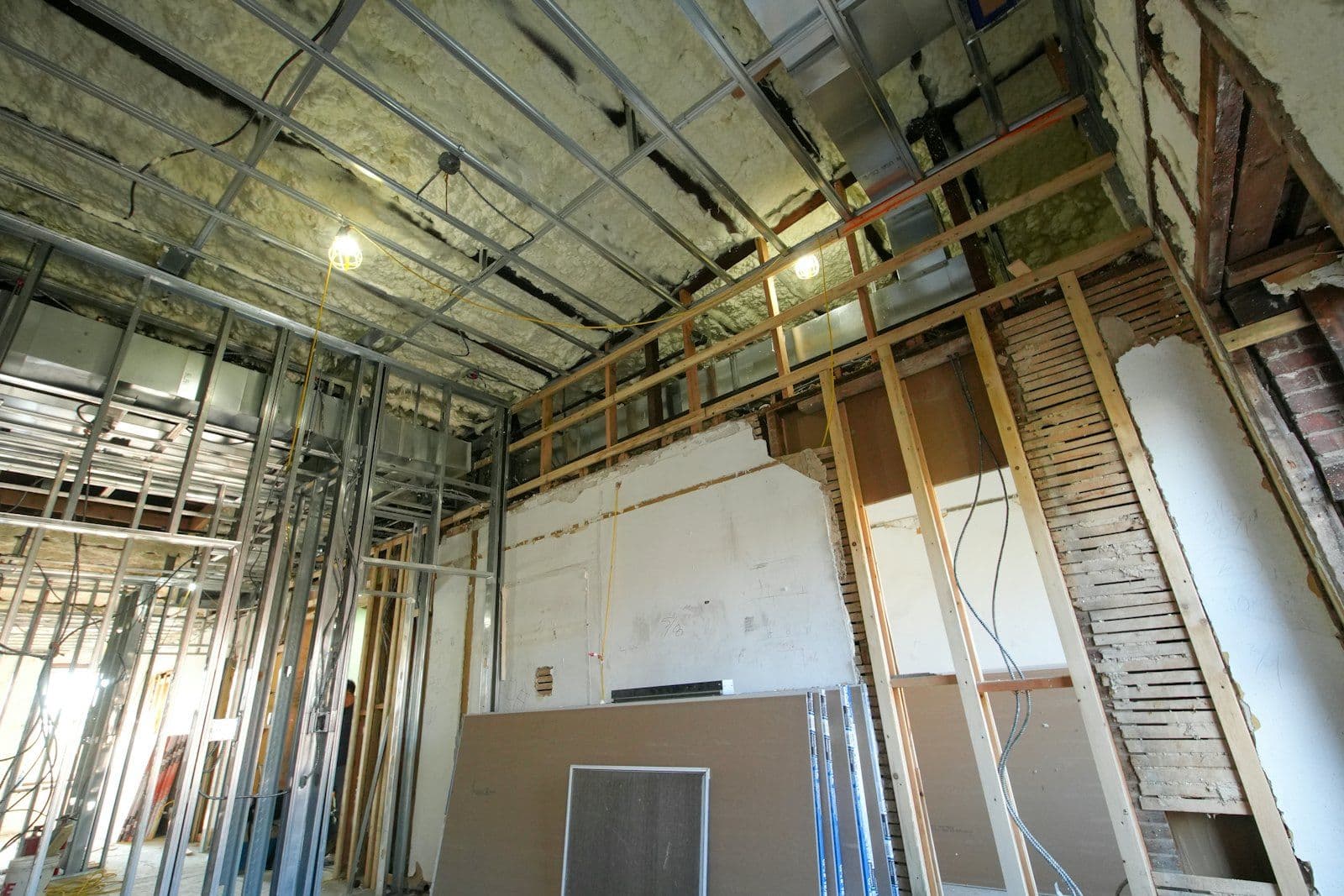 Gypsum board sheets and metal framing during a commercial drywall build-out