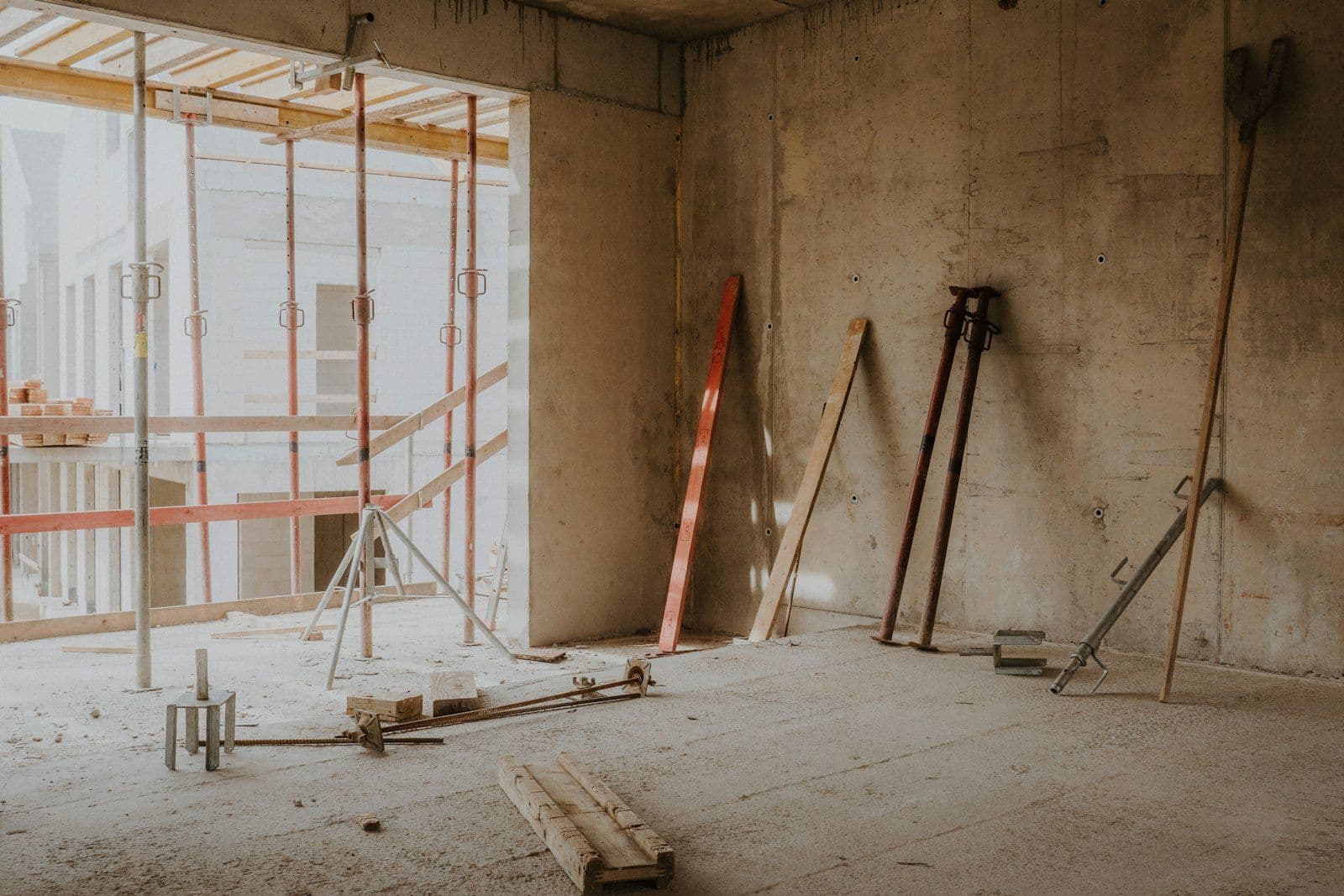 Commercial job site with scaffolding and debris awaiting rough clean